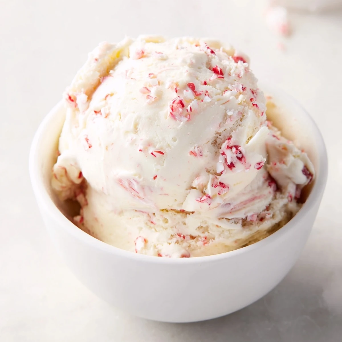 Homemade peppermint ice cream, rich and cool, perfect for a summer dessert in a bowl.