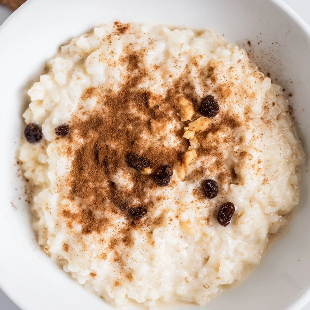 Enjoy the comforting texture of homemade creamy rice pudding with a cinnamon garnish.