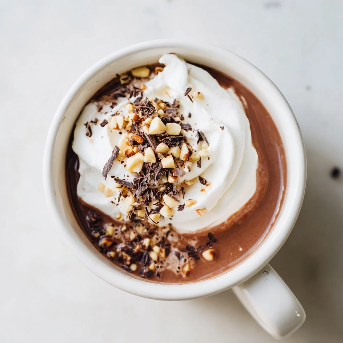 Steaming mug of Chocolate Hazelnut Hot Chocolate, showcasing a rich, dark chocolate color and warm aroma.
