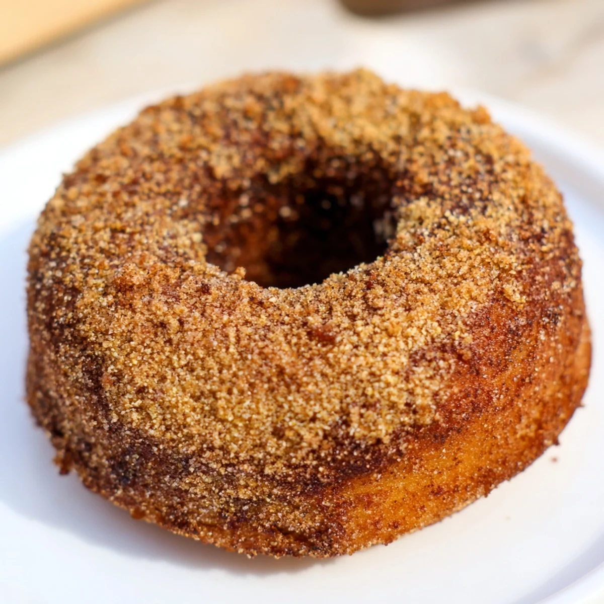 Close-up of freshly baked apple cider donuts, showcasing their soft, cake-like texture and sweet glaze.