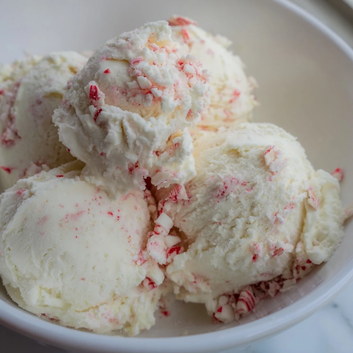 Enjoy a bowl of festive peppermint ice cream; a delightful, cool, and minty summer treat.