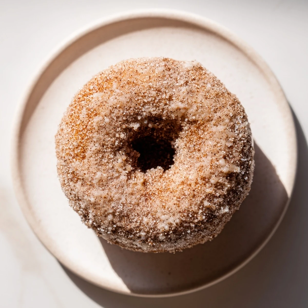 Warm, golden-brown cinnamon sugar donuts, freshly fried and ready to be enjoyed.