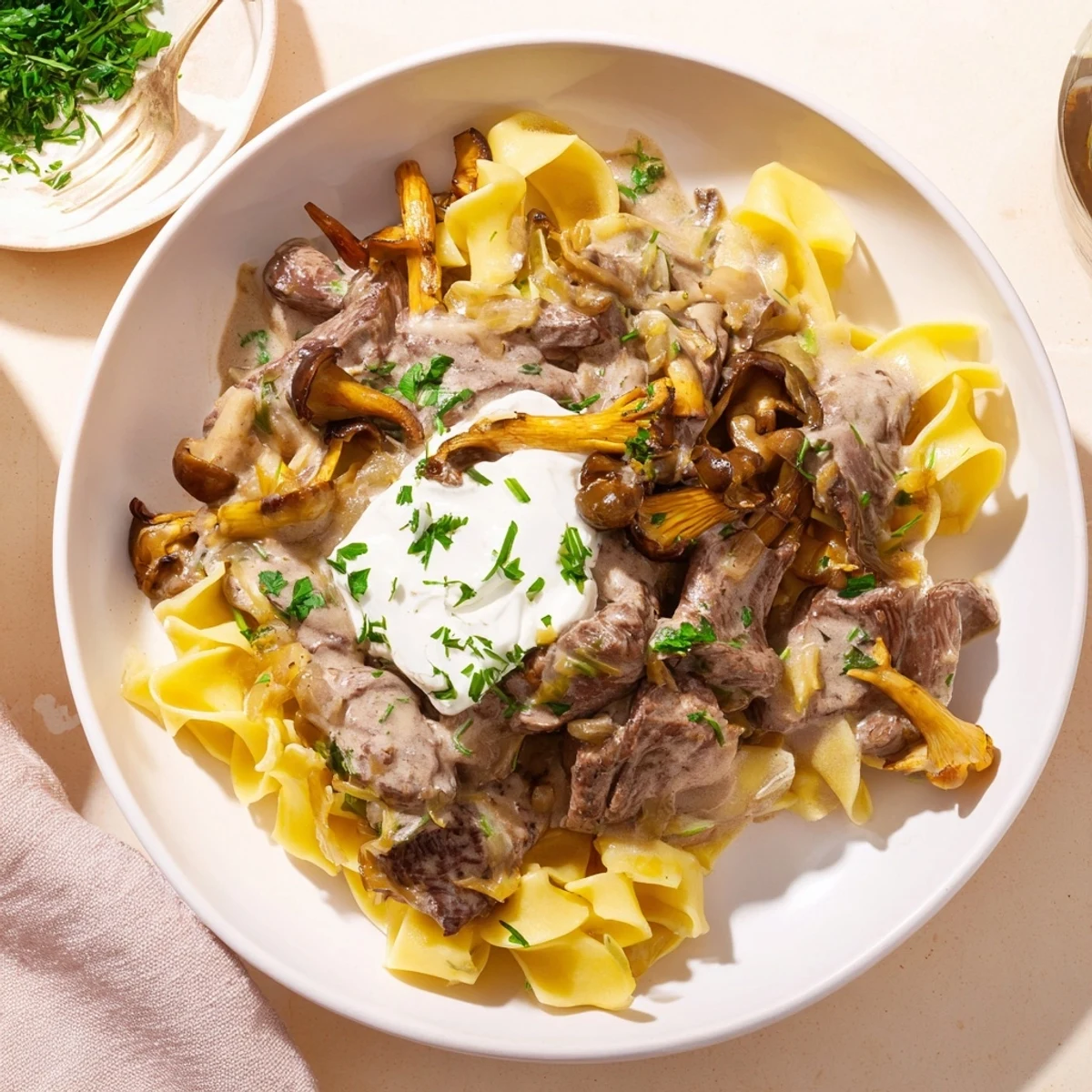 Savor the aroma of this hearty beef stroganoff featuring mushrooms, on a bed of noodles.