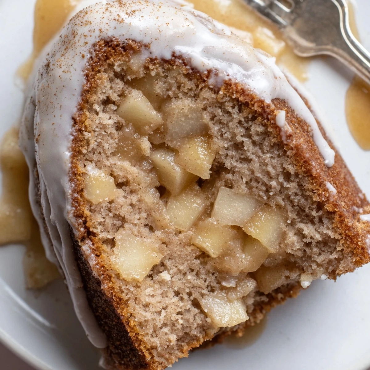 Freshly baked Spiced Apple Cider Bundt Cake with a golden-brown exterior and glistening cider glaze.