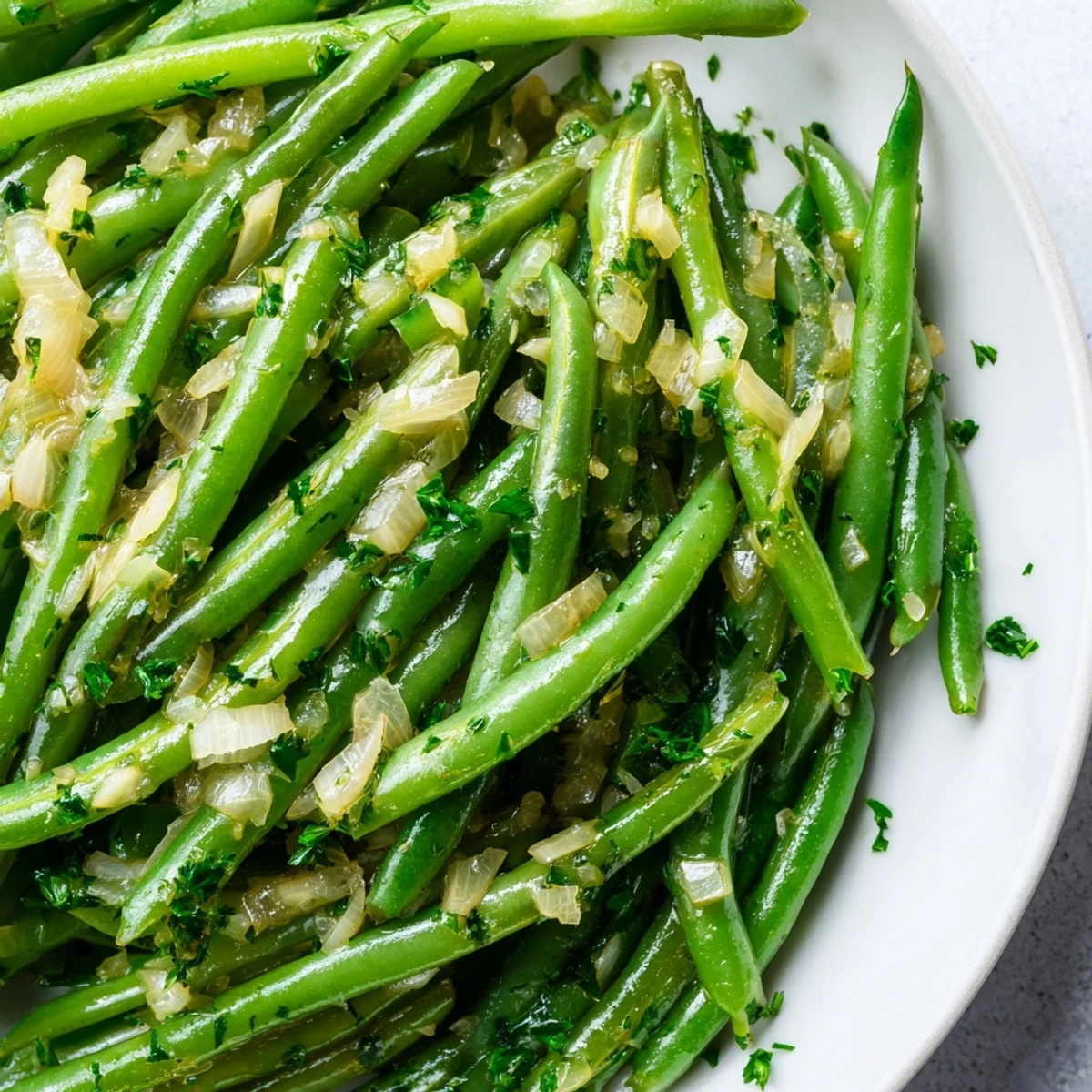 Bright green beans sautéed in rich garlic butter with tender shallots, served as a warm and savory side dish.