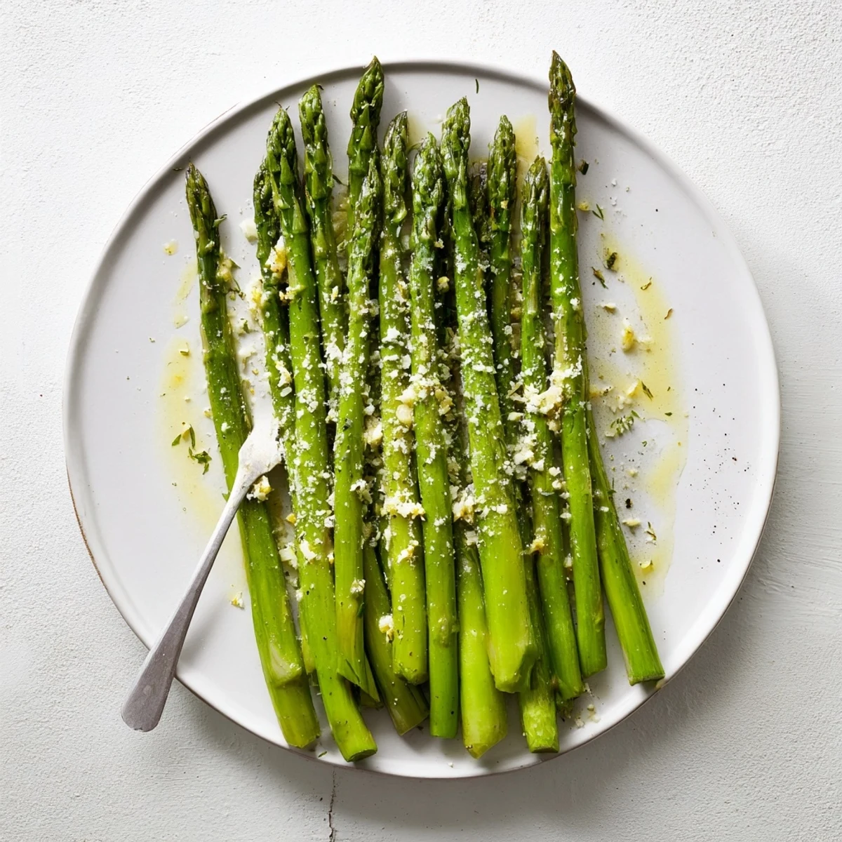 Tender asparagus spears tossed in a zesty lemon garlic sauce, finished with melted Parmesan and black pepper.