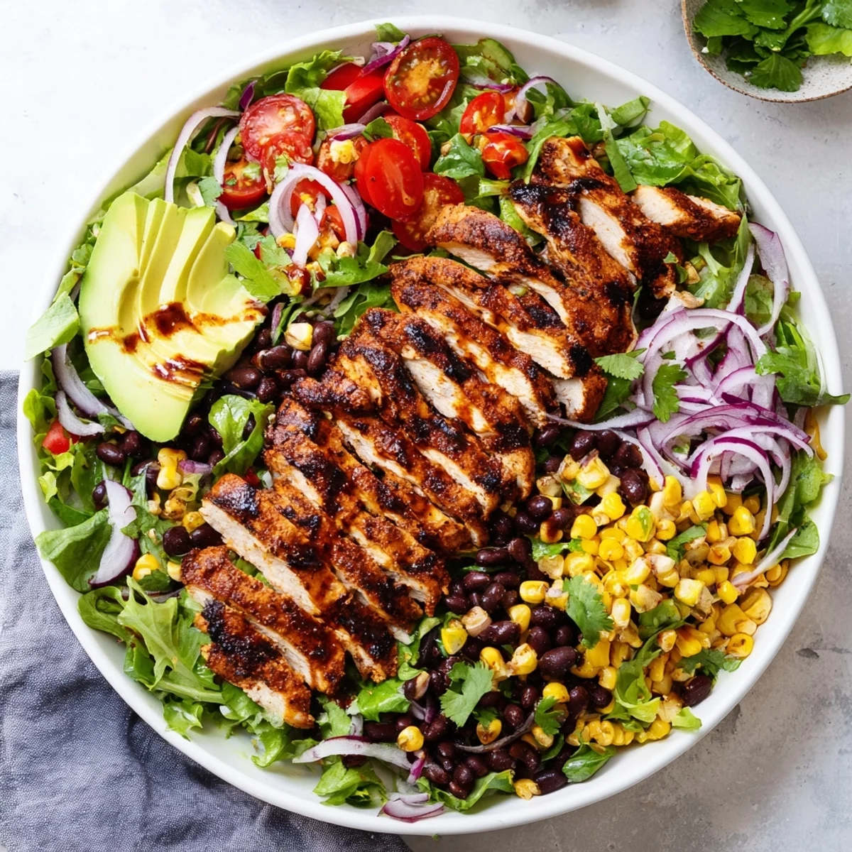 Zesty Chipotle Lime Chicken Salad showcases smoky chicken, black beans, corn, and red onion on crisp greens.