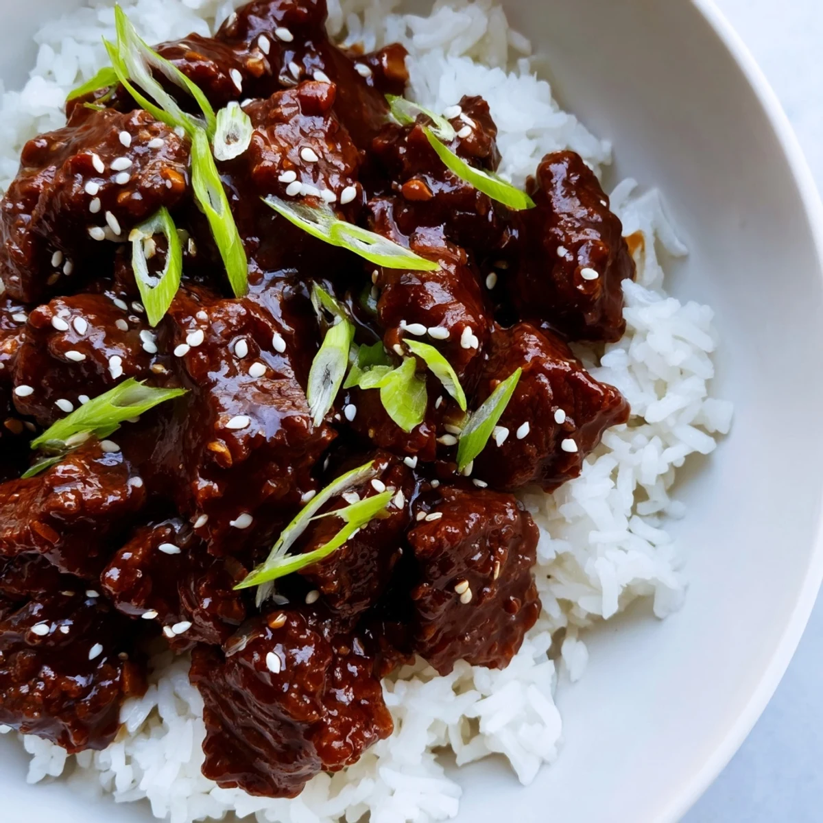A slow cooker filled with succulent Crock Pot Korean Beef, served over steamed rice for a comforting weeknight meal.