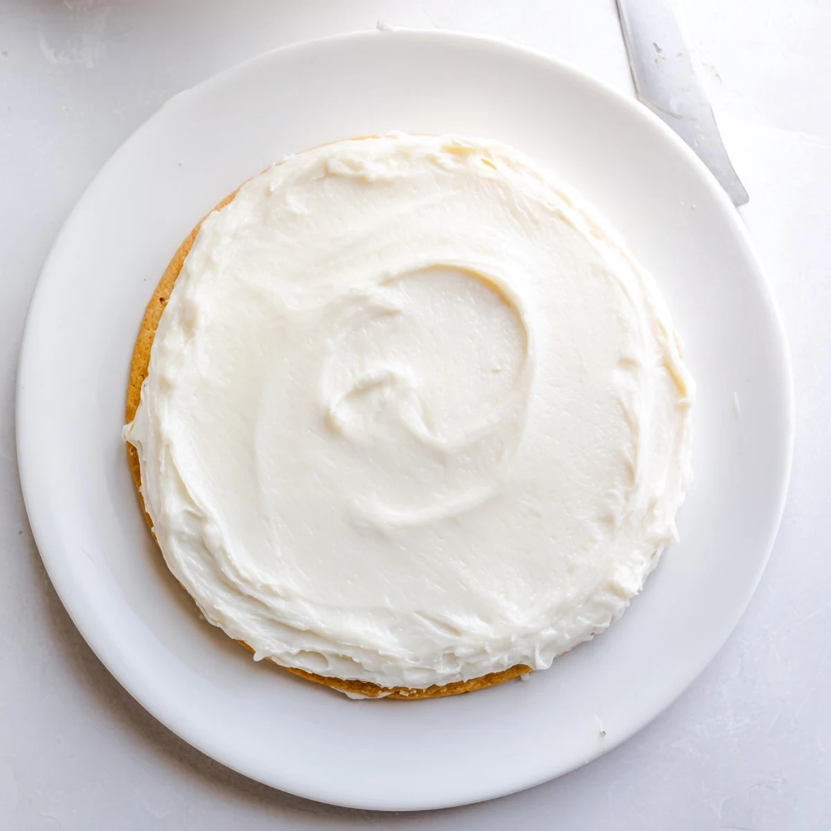 Close-up of Easy Sugar Cookie Frosting in pastel colors, perfect for piping floral designs on sugar cookies.  