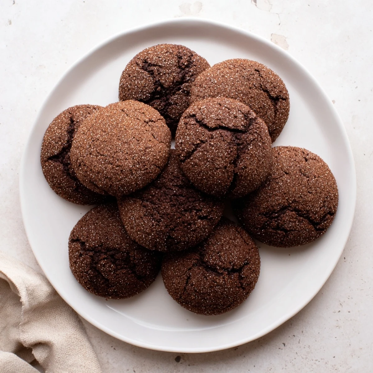 A close-up of warm Chocolate Snickerdoodles showcasing their soft centers and rich cocoa crumb.  