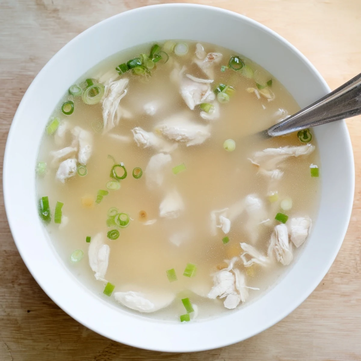 Traditional Korean Dakgomtang soup served hot with savory soy dipping sauce alongside