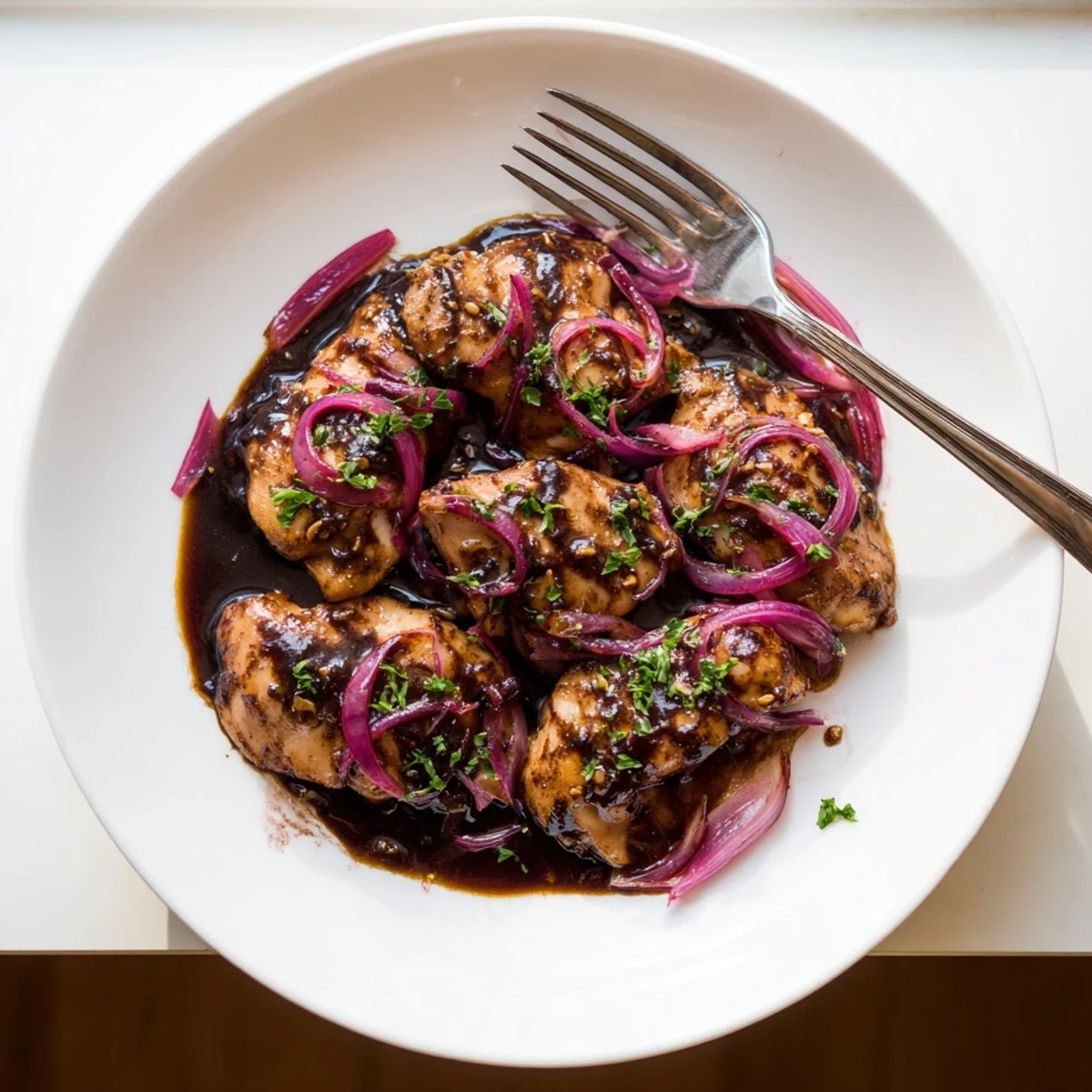 Golden brown slow cooker balsamic chicken served with thick glossy coating of honey mustard glaze