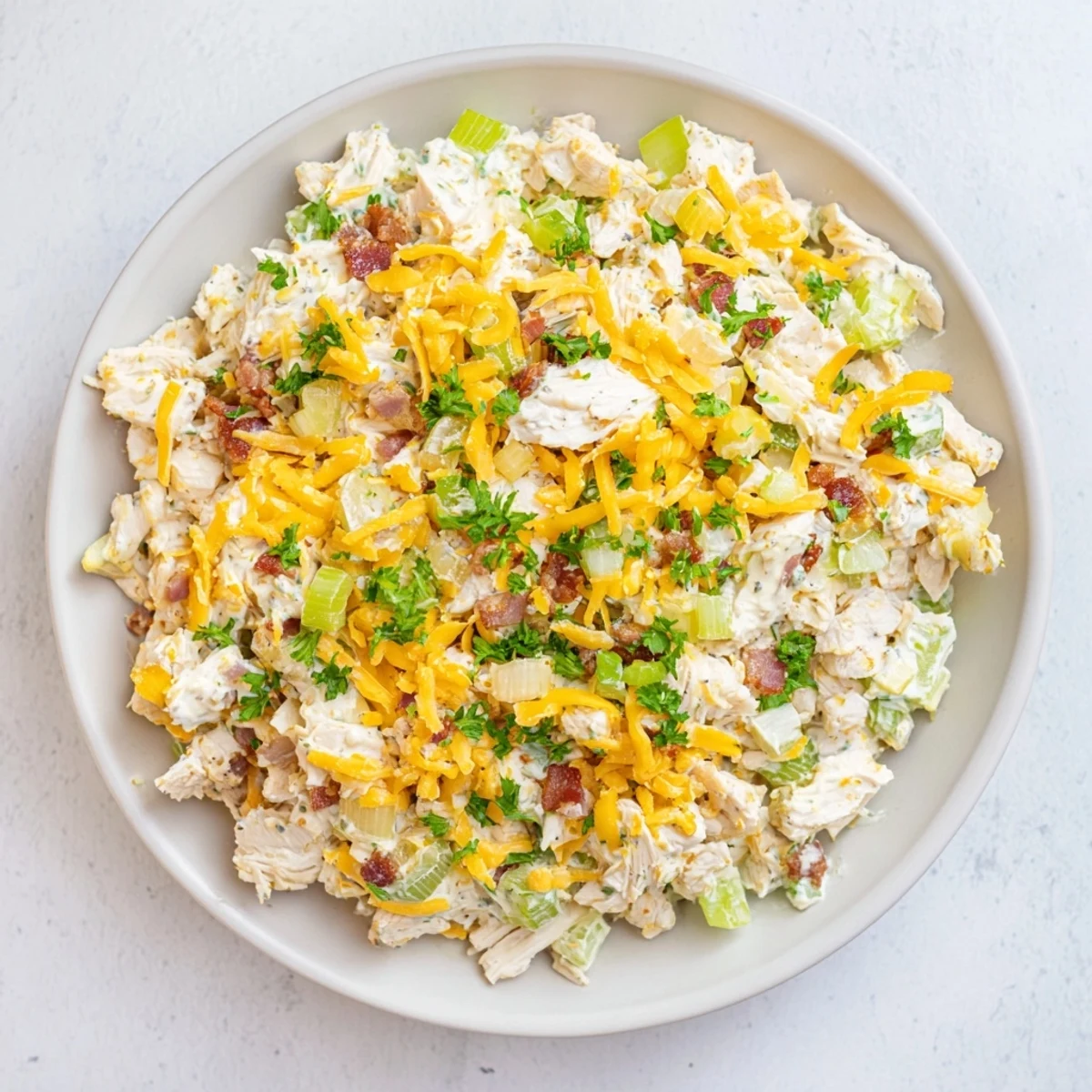 Served chilled on crisp lettuce leaves, this protein-packed cottage cheese chicken salad features sharp cheddar and smoky bacon crumbles