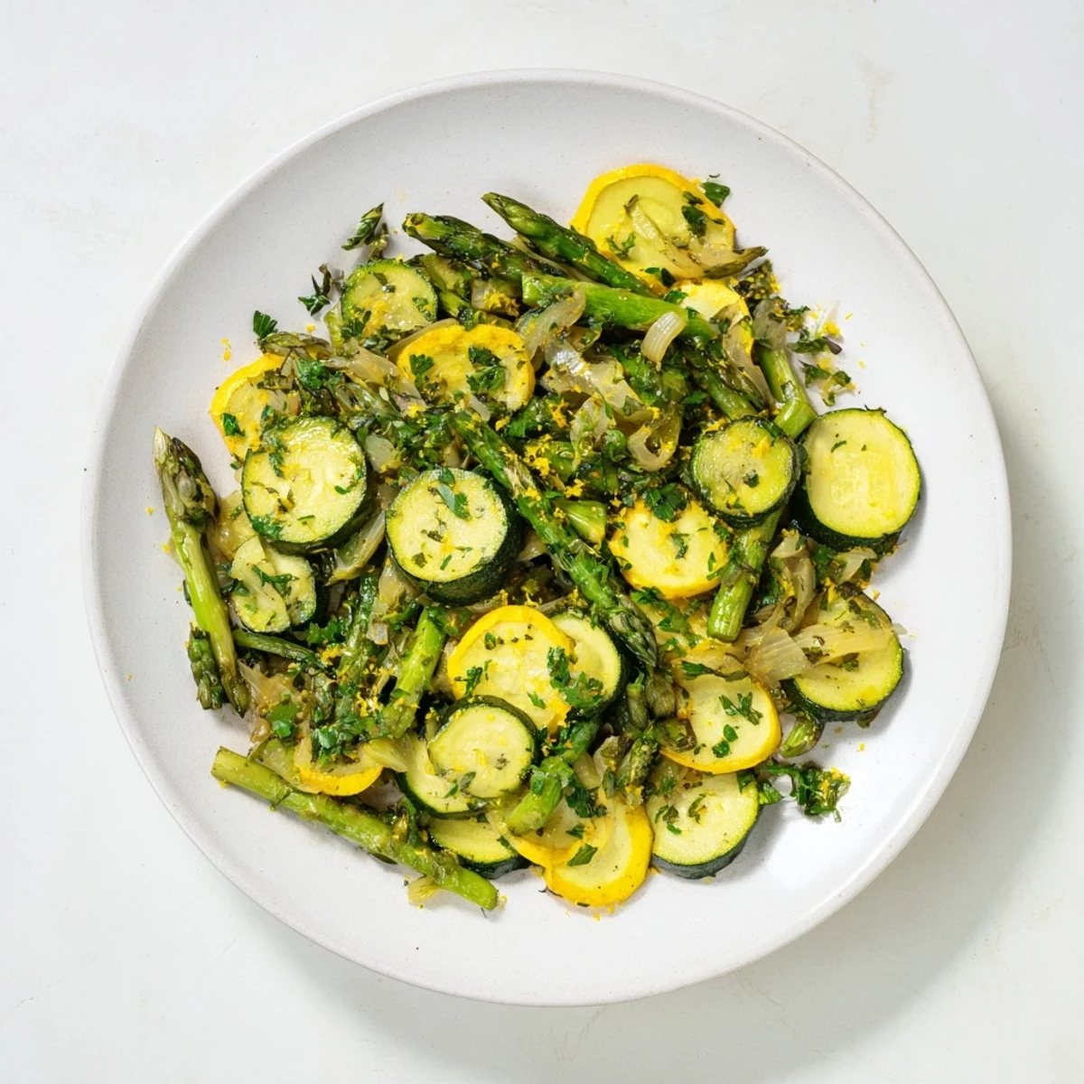 Colorful skillet of asparagus with zucchini and squash sautéed with garlic and fresh herbs