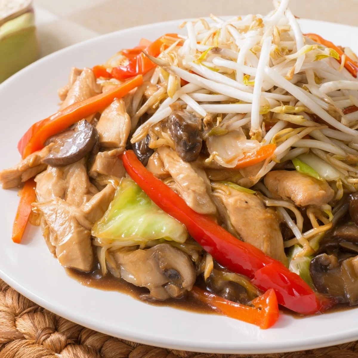 Colorful Chop Suey stir-fry with tender chicken, crisp vegetables, and glossy savory sauce served over steamed white rice in a bowl