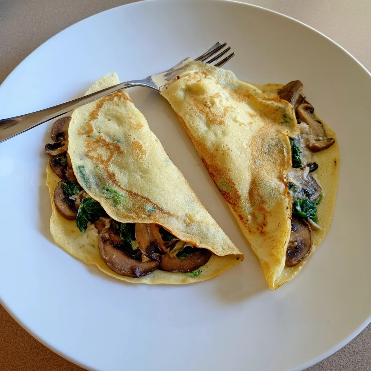 Savory crepes stuffed with golden mushrooms and cheese served hot for brunch