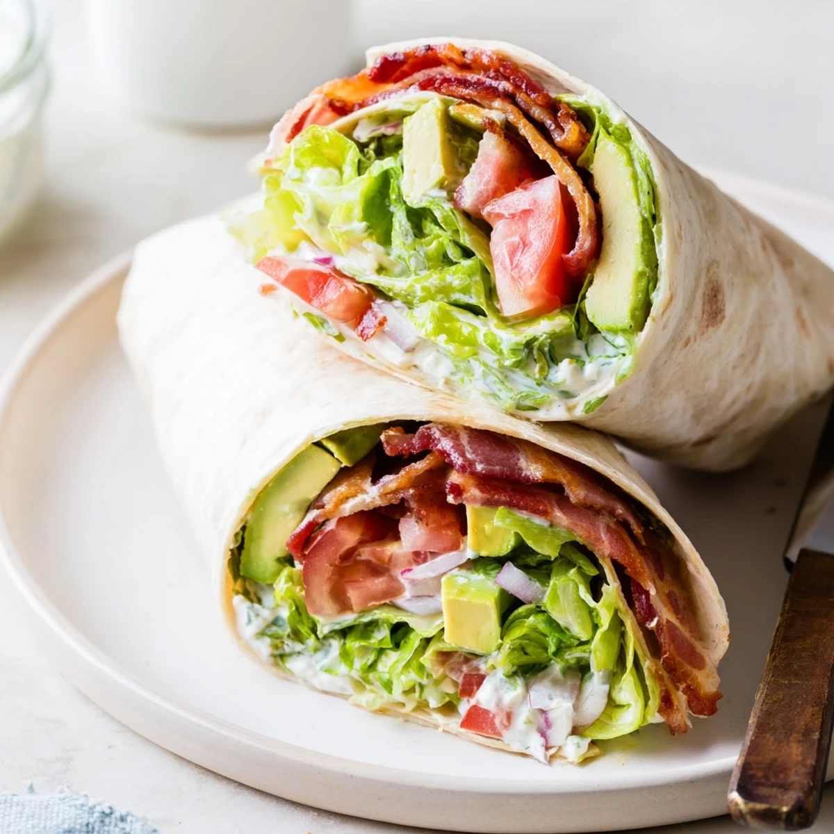 Foil wrapped Meal Prep BLT Wraps chilled in fridge, savory bacon inside