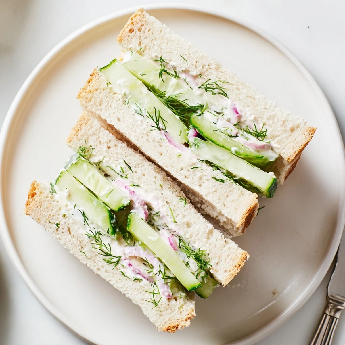 Quick Cucumber Salad Sandwiches served cut in halves, tangy yogurt mayo, chives