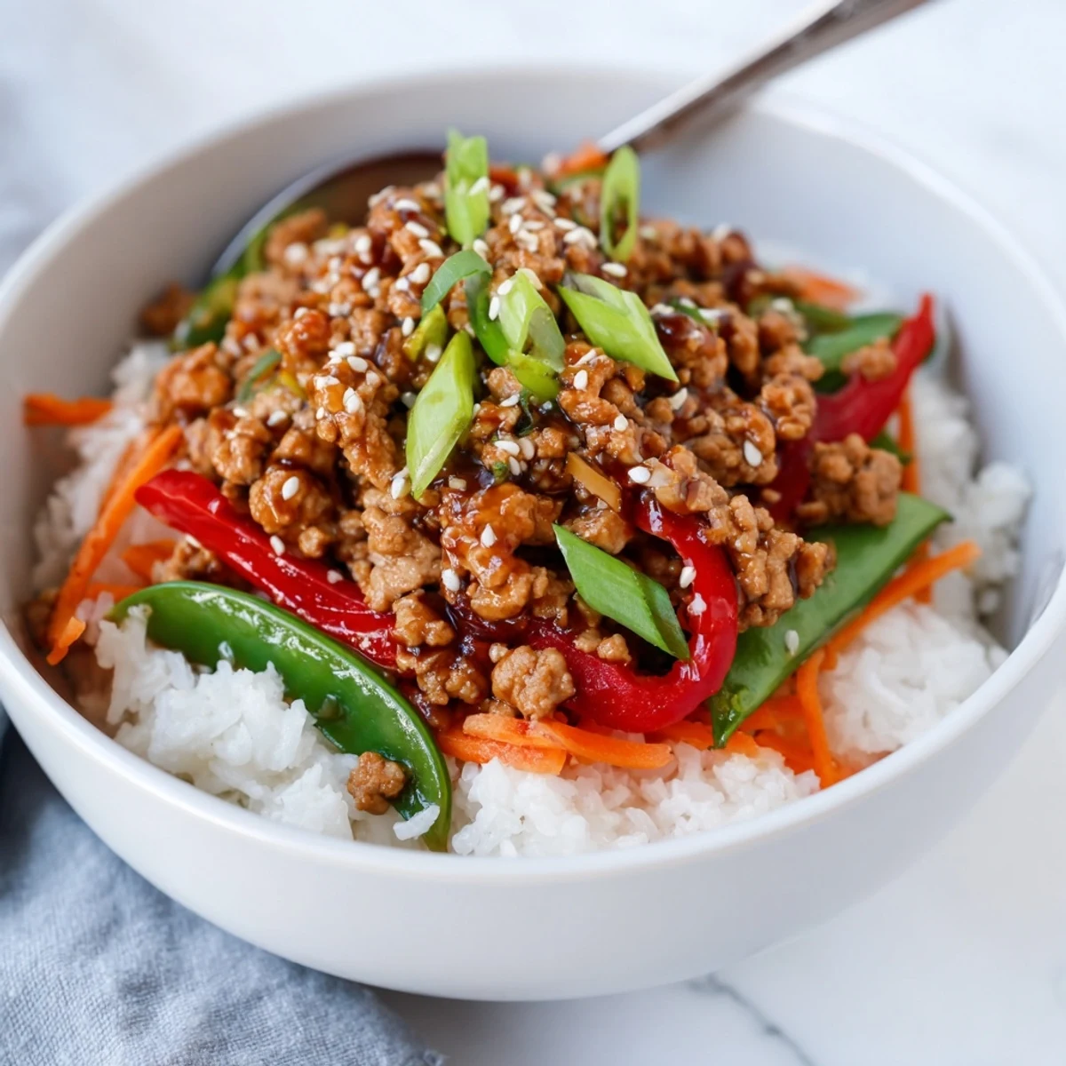 Teriyaki Turkey Rice Bowls served with a drizzle of sriracha.