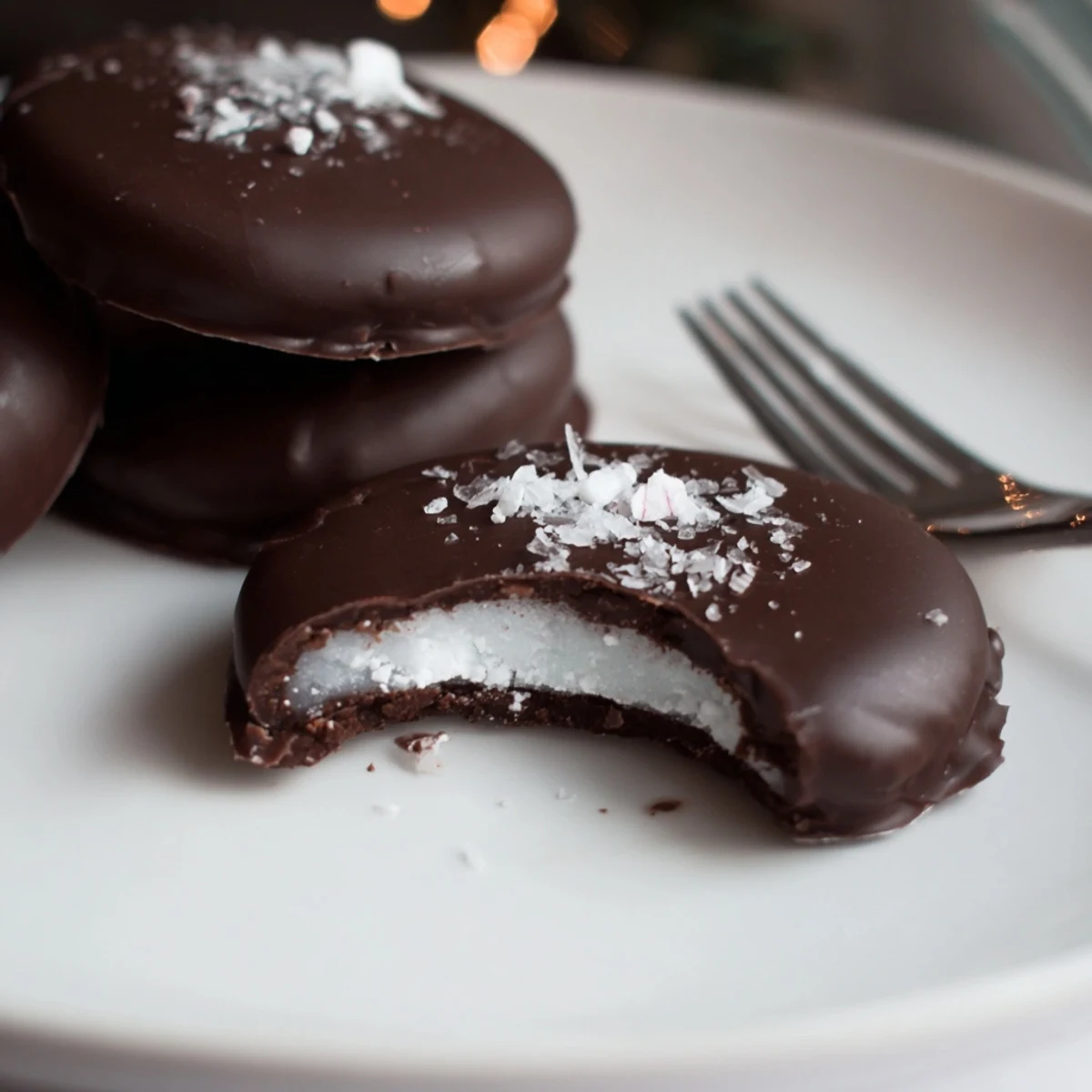 Homemade Peppermint Patties with glossy dark chocolate, chilled on parchment.