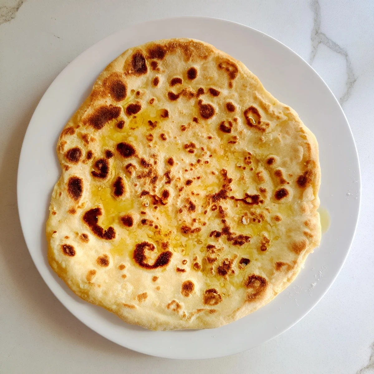 Golden Turkish Bazlama flatbread with pillowy soft texture and slightly charred spots