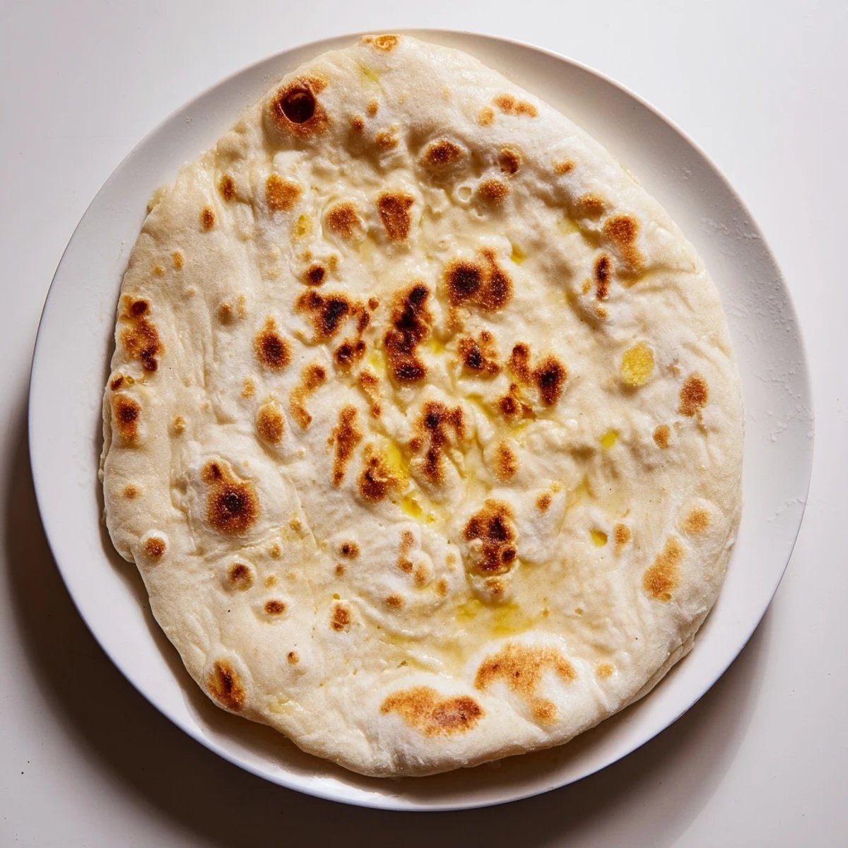 Homemade Turkish Bazlama bread puffs up beautifully in a hot cast iron skillet