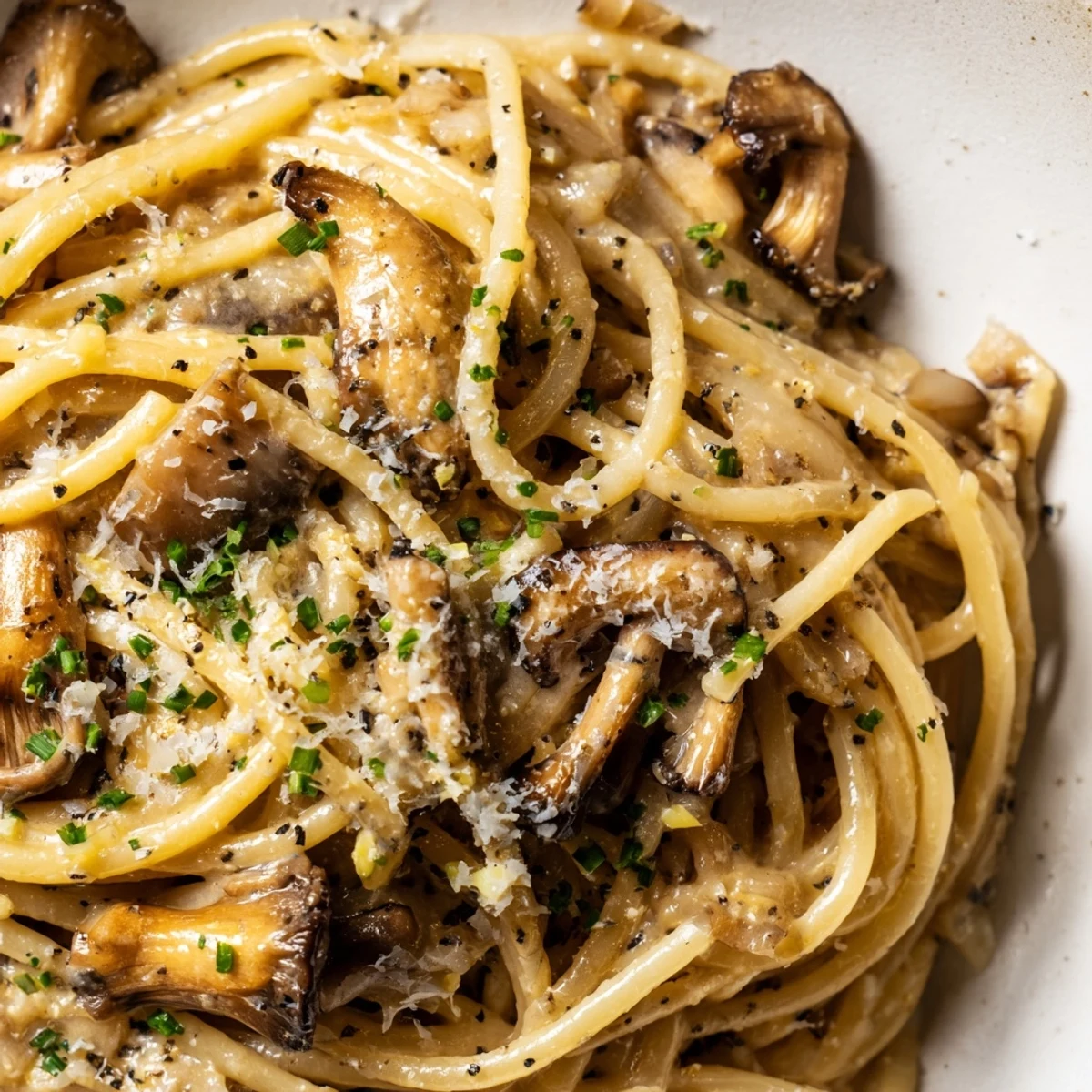 Steaming bowl of Japanese-Italian fusion pasta featuring sautéed mushrooms in rich umami cream sauce with sesame seeds