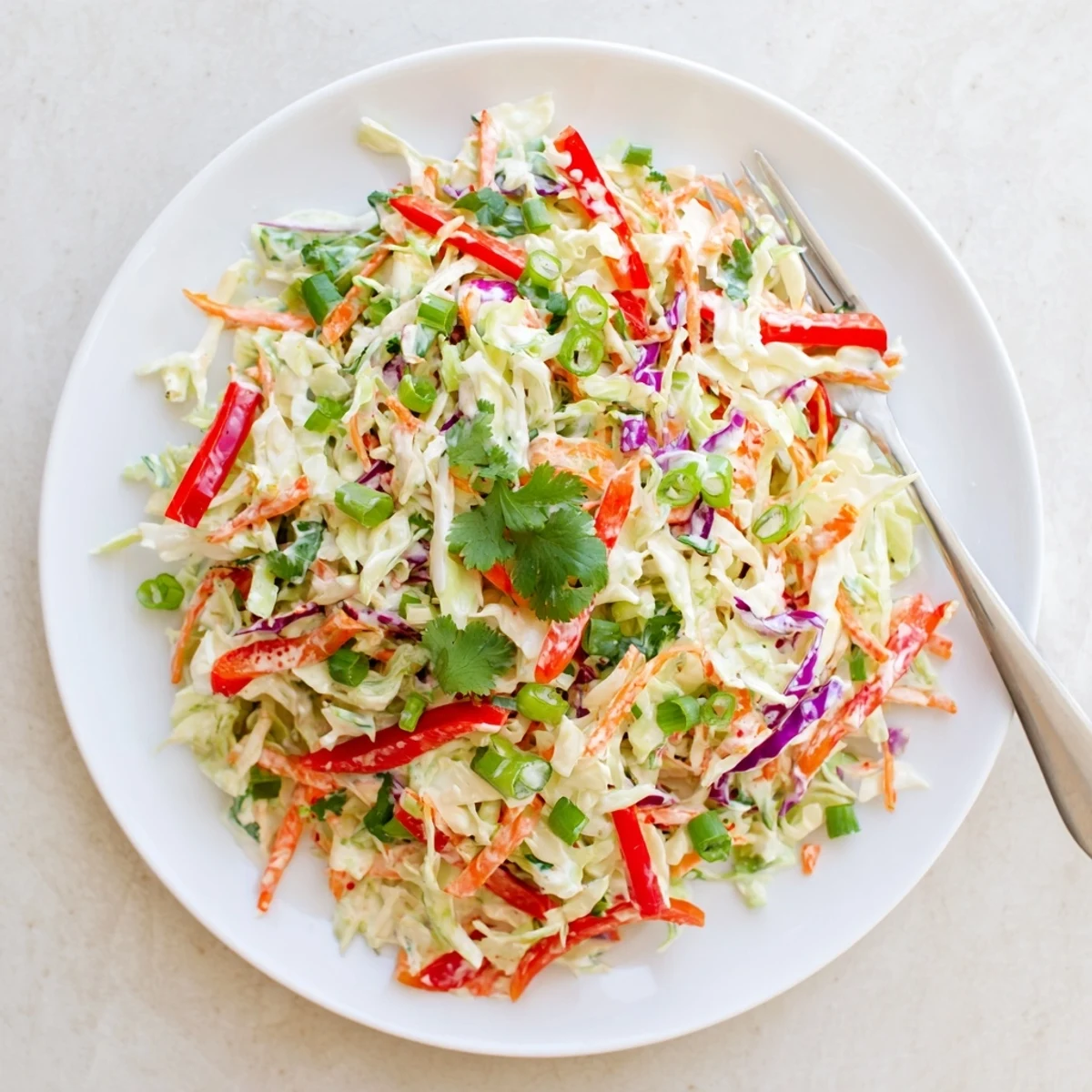 Heaping bowl of refreshing summer slaw topped with cilantro, perfect for picnics and barbecue side dishes