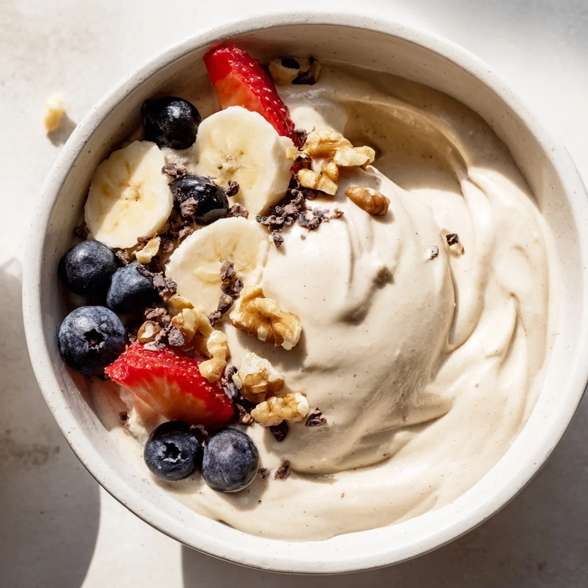 Dairy-free healthy nice cream recipe served in chilled bowls with colorful fruit garnishes