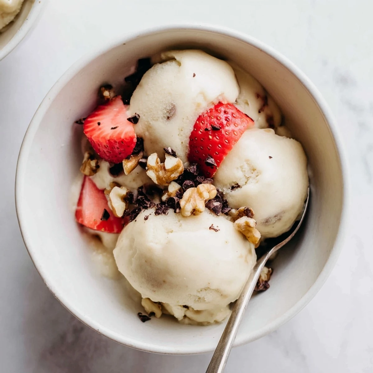 Dairy-free banana nice cream recipe showing smooth soft serve texture in rustic glass serving dish
