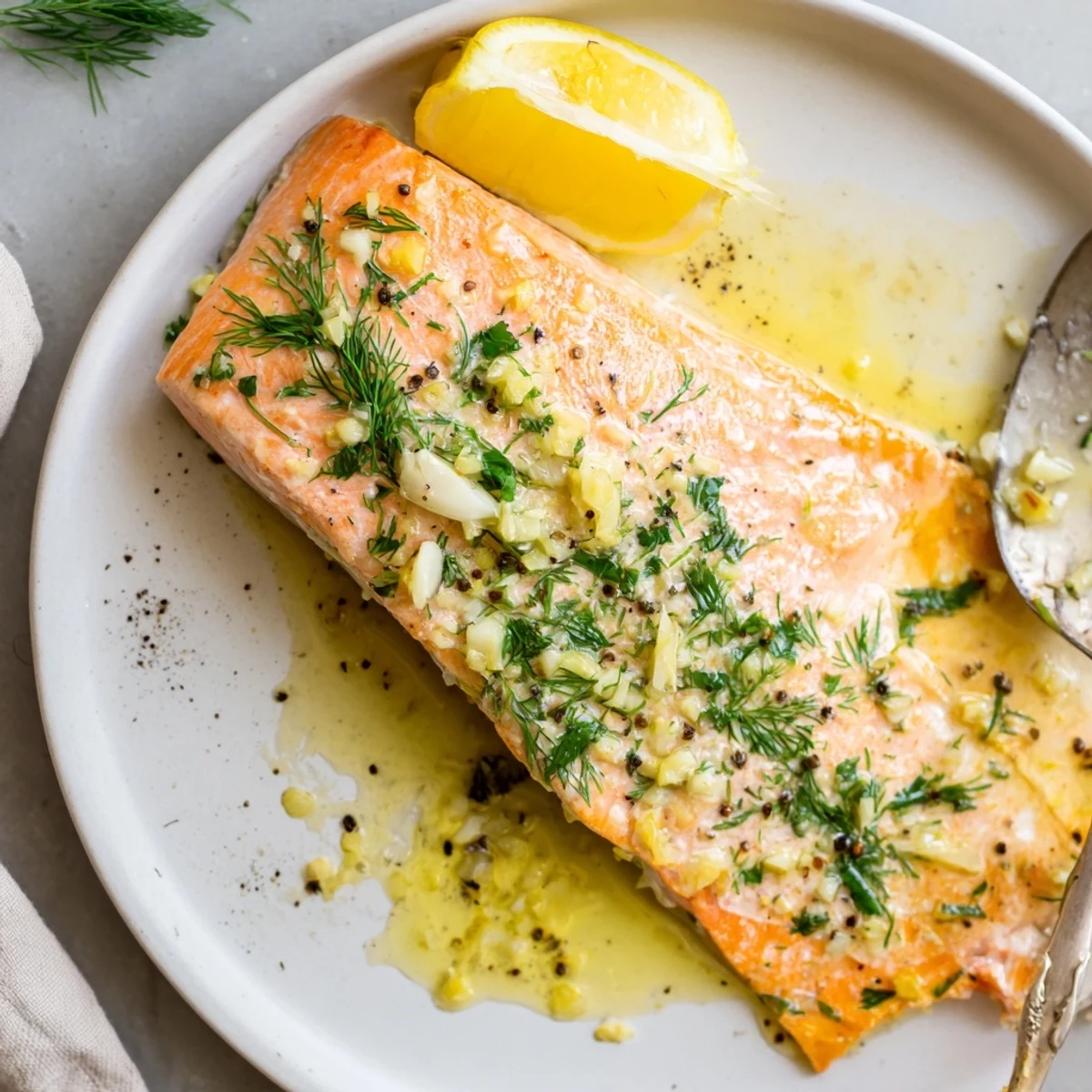 Freshly baked Garlic Butter Ghee Salmon Bake, flaky fillets topped with herbs