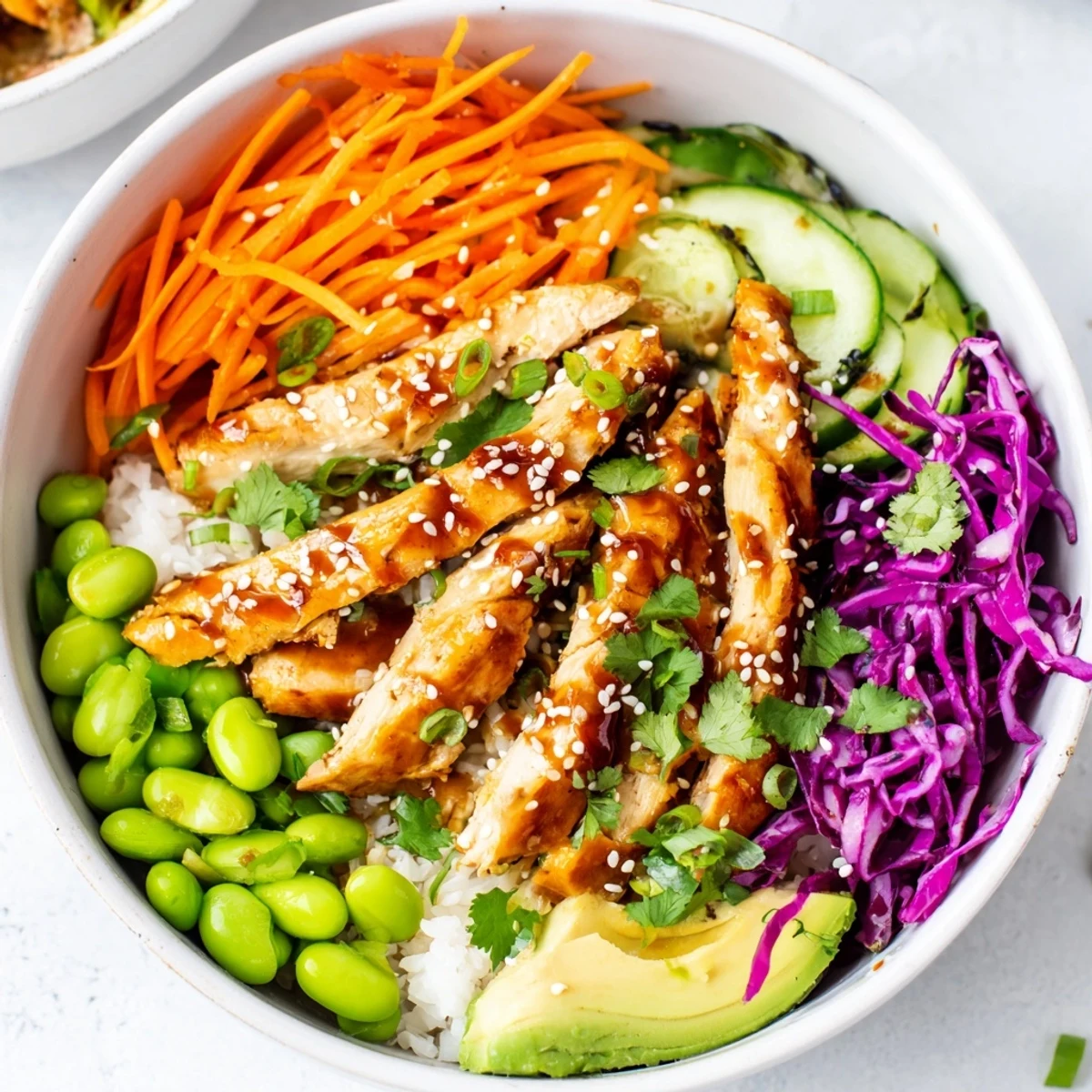 Golden marinated chicken strips nestled over crisp vegetables in this Asian Inspired Chicken Power Bowl