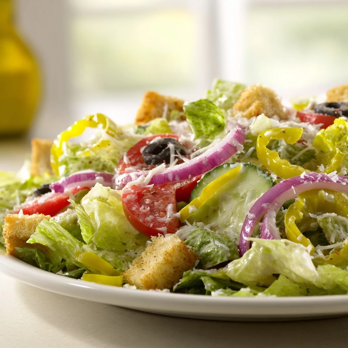 Crisp Olive Garden Salad topped with crunchy croutons and creamy Parmesan cheese