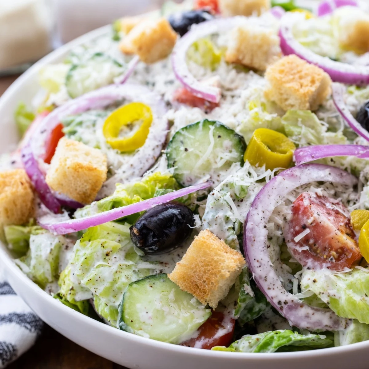 Fresh Olive Garden Salad glistening with tangy Italian dressing and colorful vegetables