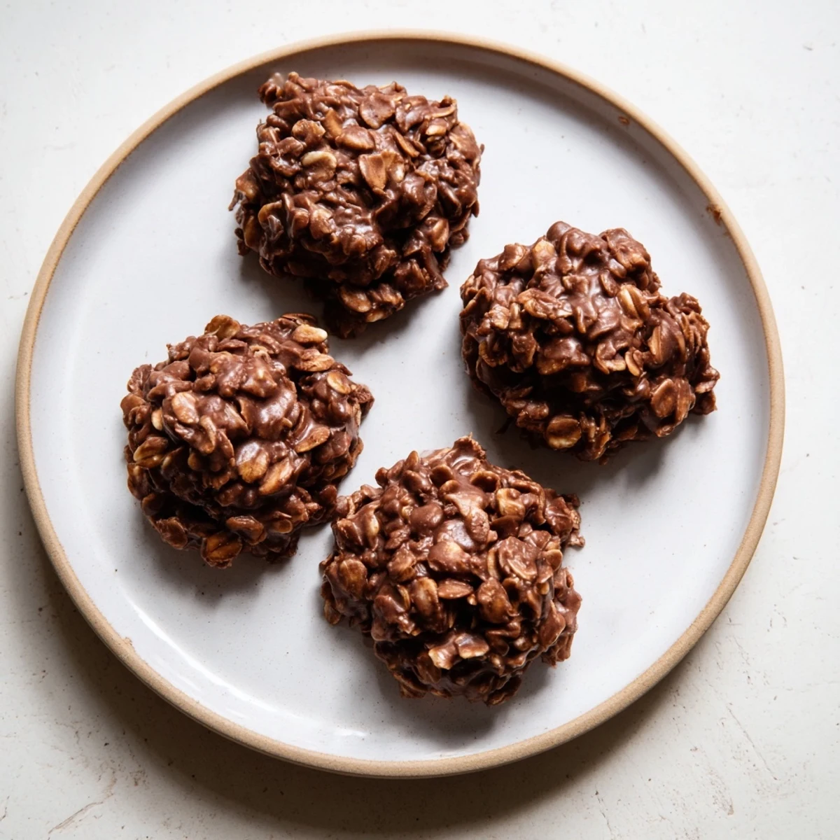 Rich chocolate oatmeal no bake cookies cooling on a sheet ready for snacking