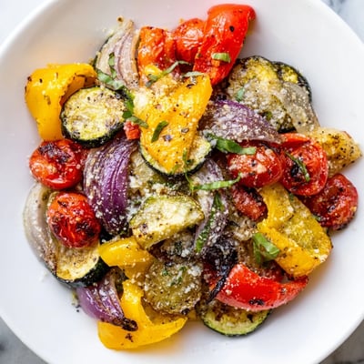Colorful Roasted Veggies with Italian Seasoning fresh from the oven on a baking sheet, paired nicely with a fork for a healthy side.