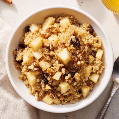 Serving suggestion for Healthy Quinoa Apple Breakfast with a drizzle of honey and a sprinkle of cinnamon on top.