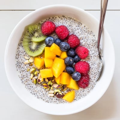 Chilled Coconut Chia Pudding in glass jars, garnished with vibrant berries